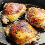 Pan Fried Chicken: Easy & Delicious Weeknight Meal 9 Golden-brown pan-fried chicken thighs in a cast-iron skillet, crispy on the outside and juicy inside, garnished with fresh herbs.