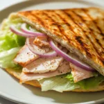 Grilled TikTok cottage cheese flatbread wrap with spinach and ham on a plate