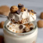 Spoonful of cookie dough cottage cheese mousse with crumbs and chocolate