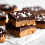 stacked homemade chocolate peanut butter protein bars with sea salt