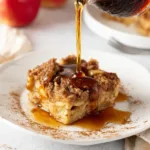 Apple french toast bake with streusel topping drizzled with maple syrup