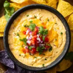 Cottage cheese queso topped with cilantro and onion served with tortilla chips