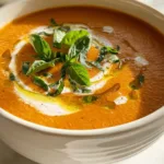 Creamy high-protein tomato soup with basil and olive oil drizzle