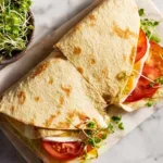 folded simple cottage cheese flatbread air fryer wraps with tomato and sprouts