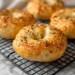Golden protein bagels cooling on rack, high-protein breakfast recipe