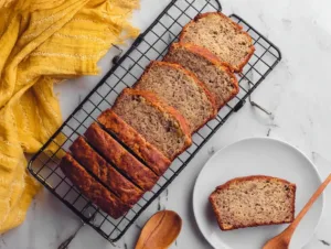 Healthy Flourless Banana Bread – No Flour, No Fuss, All Flavor 15 Sliced flourless banana bread on cooling rack with one slice on plate