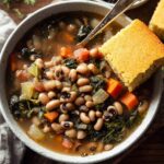 5-Ingredient Black Eyed Pea Soup – Simple & Powerful Comfort 10 Top view of black eyed pea soup with cornbread on rustic table