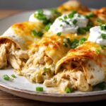 creamy chicken enchiladas with melted cheese and sour cream