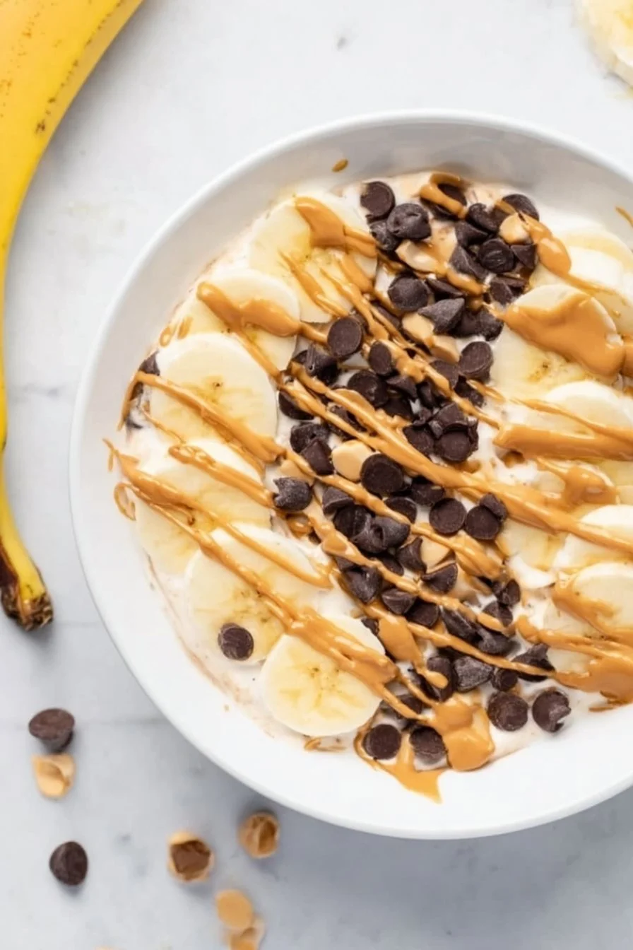 Healthy chunky monkey banana peanut butter yogurt bowl topped with slices