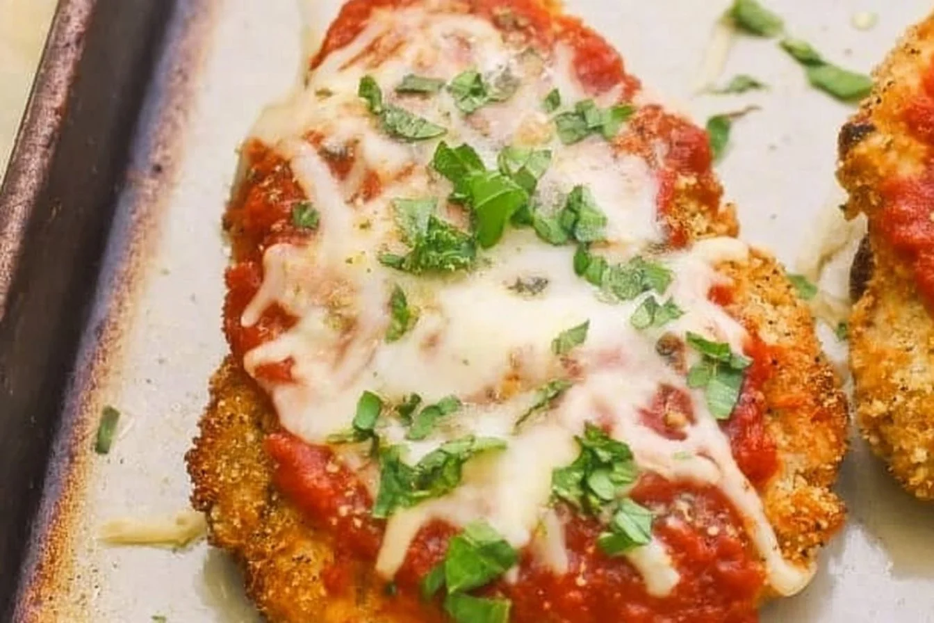 Baked chicken parmesan served with marinara sauce and cheese