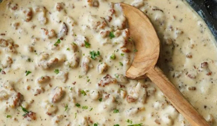 Delicious plate of biscuits and gravy with creamy sausage sauce