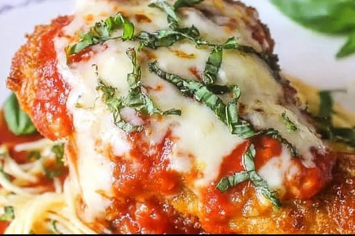 DeliciousChicken Parmesan with melted cheese and marinara sauce