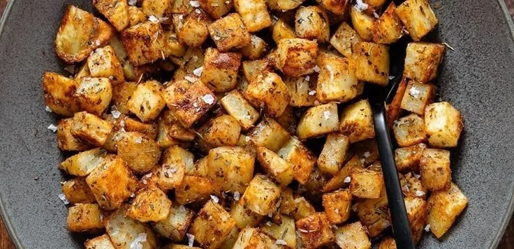 Plate of crispy breakfast potatoes seasoned and ready to serve