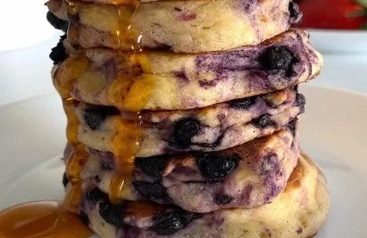 Healthy Blueberry Pancakes 4 Healthy blueberry pancakes topped with fresh blueberries and syrup