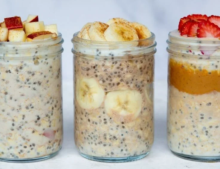 Bowl of high-protein overnight oats topped with fresh fruits and nuts.