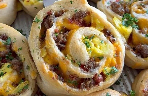 Freshly baked savory breakfast rolls on a plate, ready to be enjoyed.